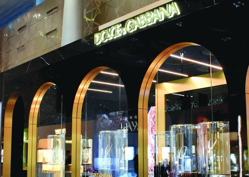 Arched retail corridor with chandelier and gold trim, a G-TCK fit-out